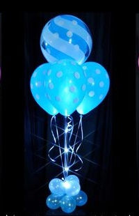 6 Blue sparkle party decoration balloons on stick arranged in a box with ribbons and small balloons