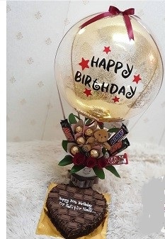 Happy Birthday printed hot air balloon with Teddy 5 Ferrero Rocher chocolates 5 dairy milk small chocolates in basket Cake 1 kg chocolate heart shape