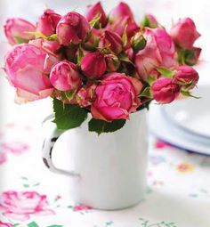 12 pink roses in a coffee mug