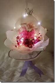 Luminous Led Light Bubble balloon with red roses petals inside and decorated with white net and red and white ribbons