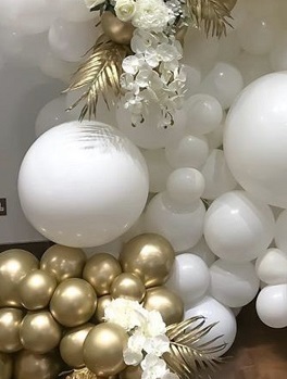 35 White and golden balloons adorned with golden painted palm leaf and white flowers