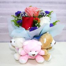 Three Teddies holding a bouquet of 1 red 1 white 1 pink rose